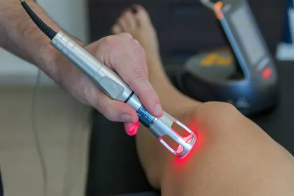 Doctor performing K-Laser therapy on patient